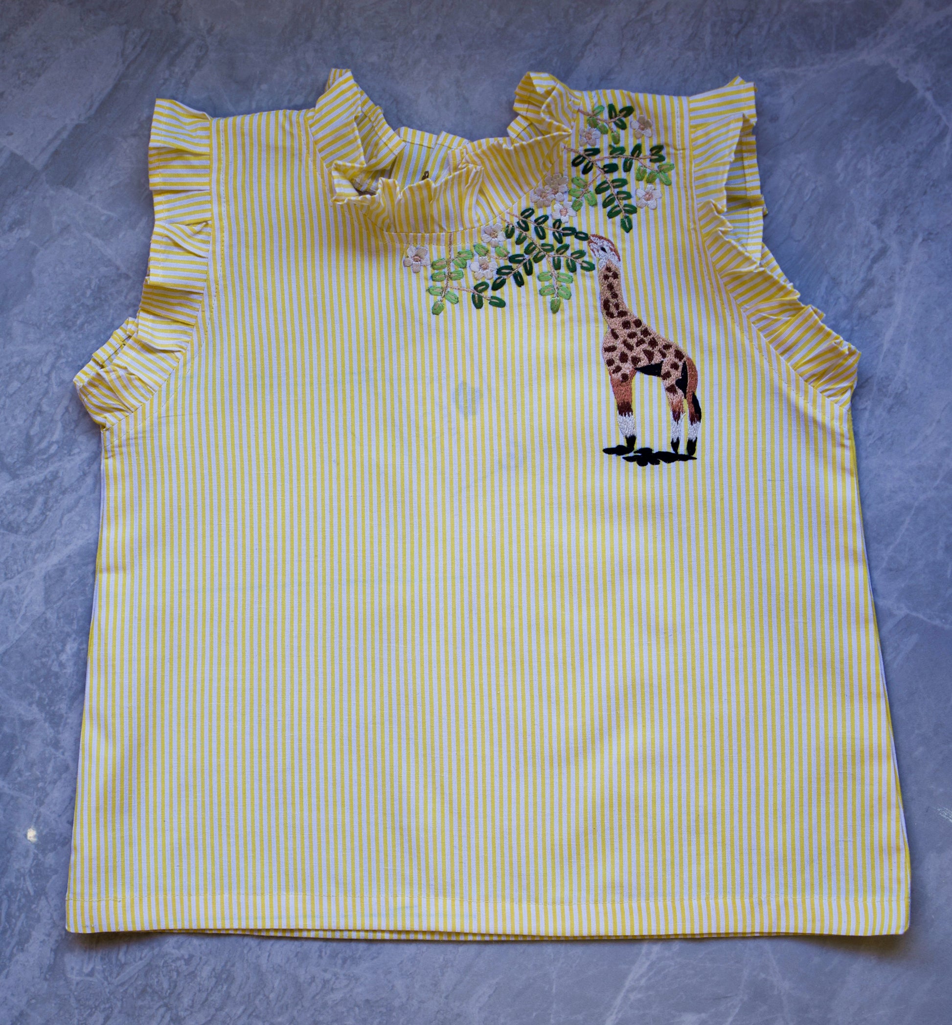 Yellow striped sleeveless top with a giraffe design